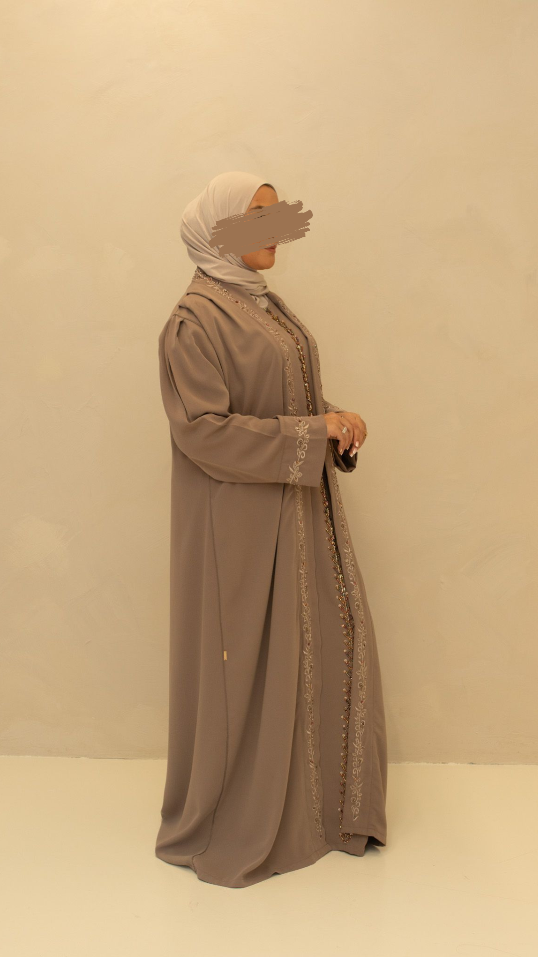 Feestelijke abaya met subtiele glans en delicate details, ideaal voor speciale gelegenheden en avondlooks.